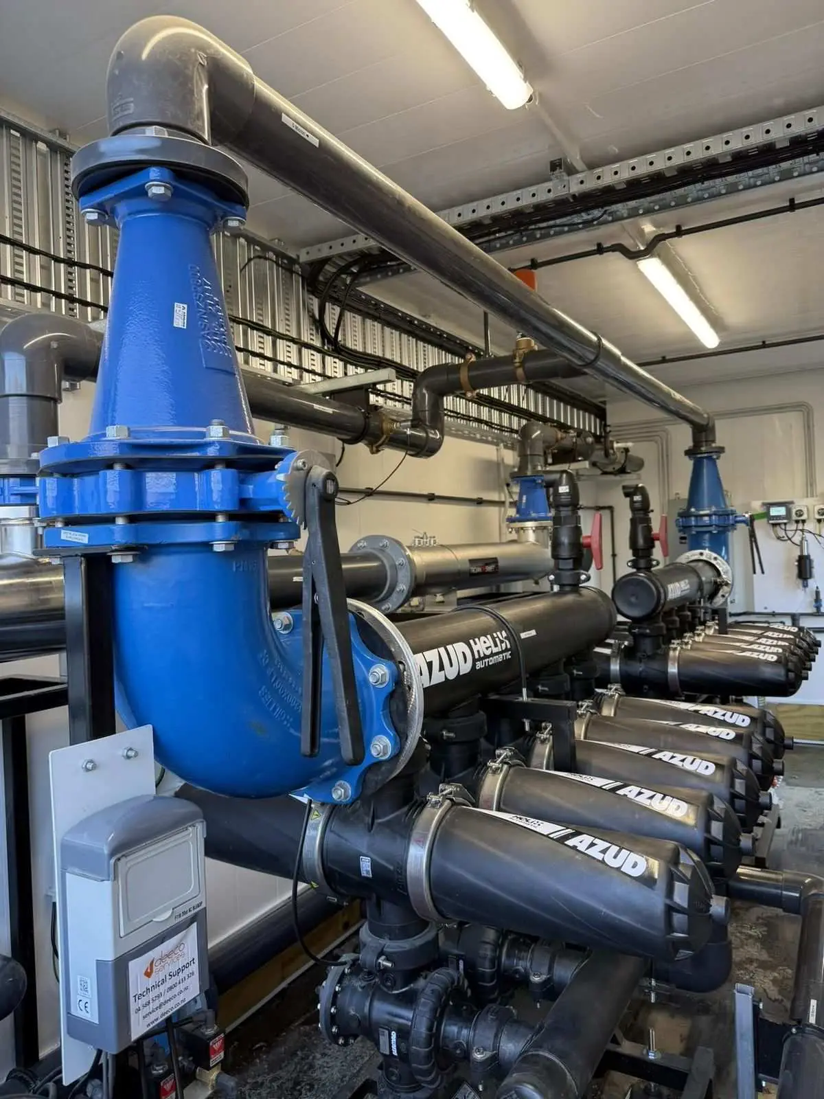 AZUD disc filtration bank and blue air release valve inside the treatment plant